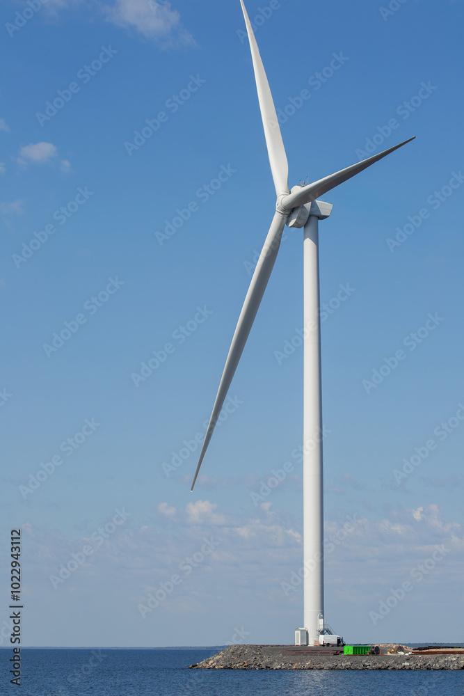 Close-up of wind turbine against blue sky. Concept of green, clean, renewable energy. Close-up of wind turbine against blue sky. Concept of green, clean, renewable energy.