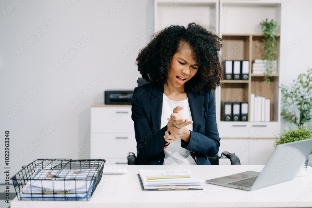 Overworked young African businesswoman office worker suffering from neck pain after had a long day Overworked young African businesswoman office worker suffering from neck pain after had a long day
