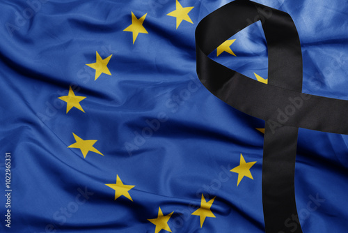 waving national flag of european union with black mourning ribbon .tragedy concept