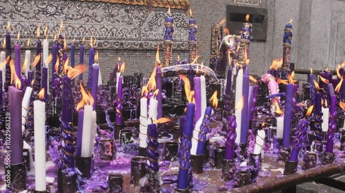 group of handmade and ornamental candles lit by the Lord of Miracles in Lima, Peru photo