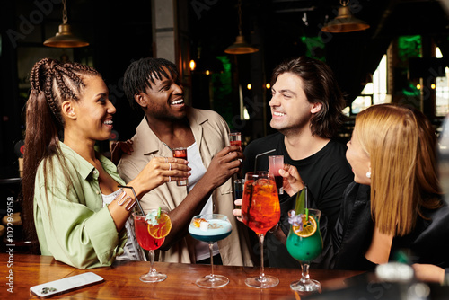 A lively atmosphere as young professionals celebrate together, laughing and toasting drinks. photo