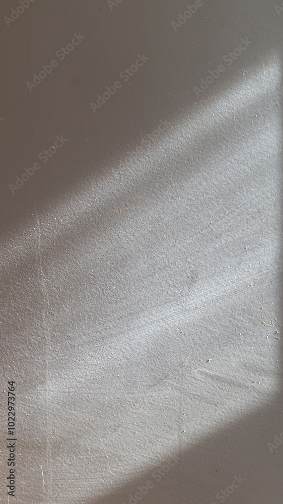 The white textured surface is illuminated from the stone by the sun at an angle The white textured surface is illuminated from the stone by the sun at an angle
