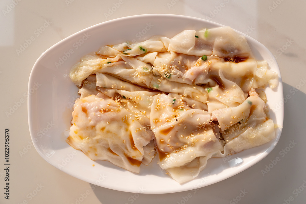 top view traditonal Cantonese food of cheong fun or rice noodle rolls or steamed vermicelli rolls horizontal composition top view traditonal Cantonese food of cheong fun or rice noodle rolls or steamed vermicelli rolls horizontal composition