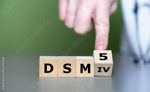 Hand turns cube and changes the expression 'DSM IV' to 'DSM 5'. Symbol for the update of DSM (Diagnostic and Statistical Manual of Mental Disorders) guideline.