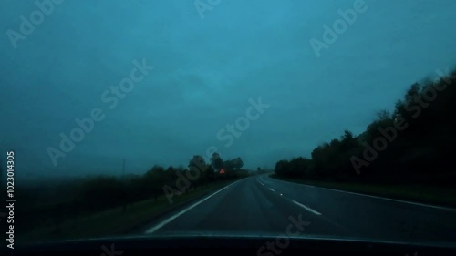 driving point of view dashboard Scottish highlands Cairngorms national park hills mountains rainy. 