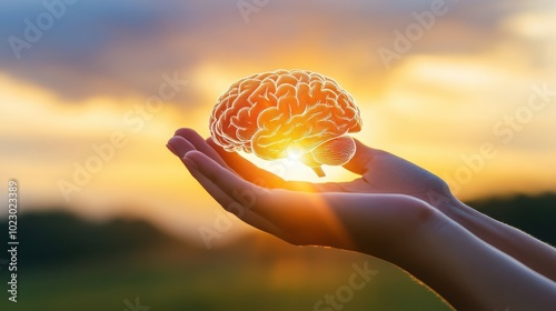 Hand holding glowing brain symbolizing knowledge and enlightenment