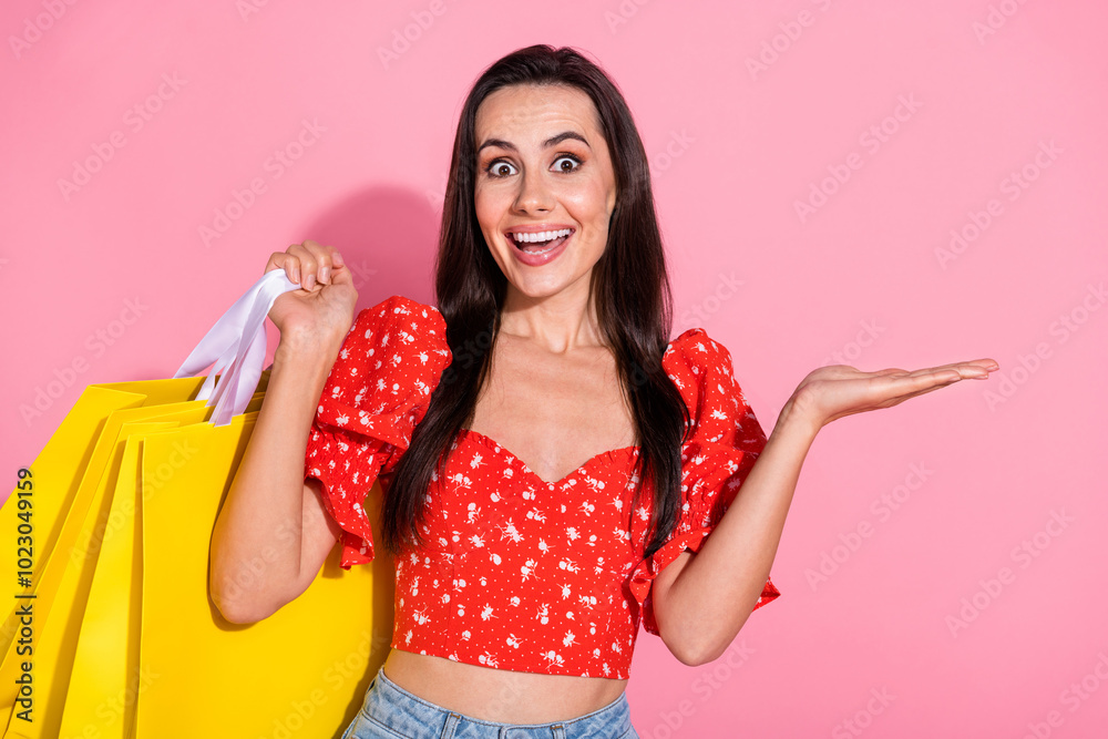 Portrait of nice young lady arm hold empty space bags wear top isolated on pink color background Portrait of nice young lady arm hold empty space bags wear top isolated on pink color background