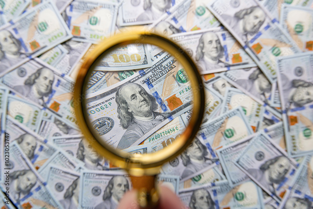 100 dollar banknote and magnifying glass 100 dollar banknote and magnifying glass