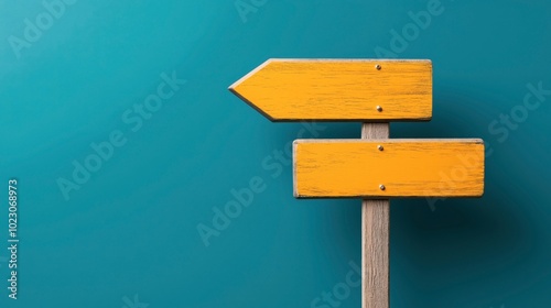 Wooden signpost with two yellow directional arrows on a blue background indicating different directions.