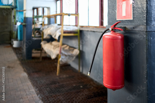 Fire extinguisher equipment in factory for fire protection system. carbon dioxide Fire extinguisher with pressure gauge on wall of production room. Concept of fire safety means of fighting fires.