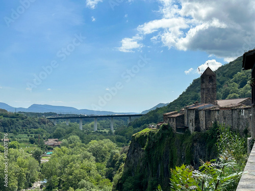 View of the city on the rock and bridge on a summer day. Castellfollit de la Roca. Spain. photo