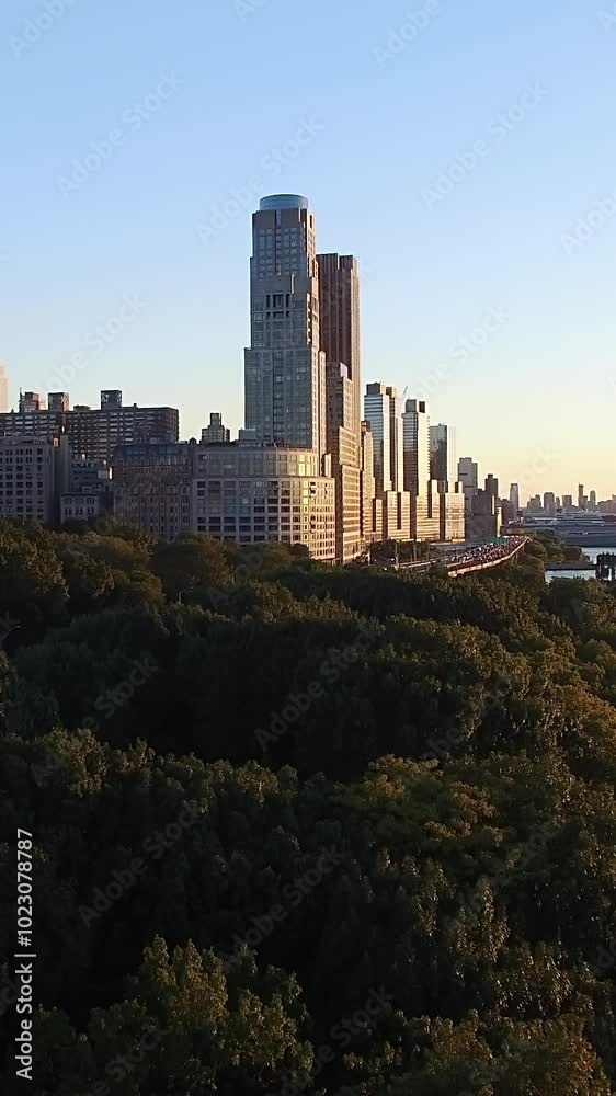 The Urban Skyline at Sunset Paints a Beautiful Picture Over Lush Green Trees Beneath it The Urban Skyline at Sunset Paints a Beautiful Picture Over Lush Green Trees Beneath it
