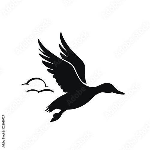 A black silhouette of a flying duck or goose with outstretched wings 
