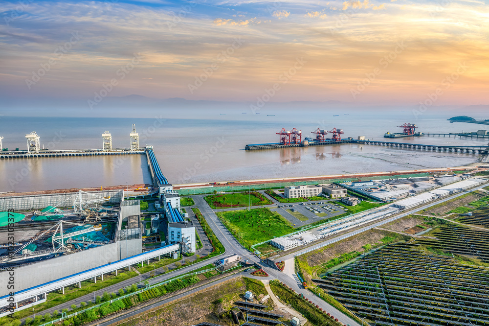 Aerial shot of oil pipelines and cranes at seaside port at sunset Aerial shot of oil pipelines and cranes at seaside port at sunset