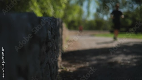 Man running in the park on a blurred background. Slow Motions. 4K