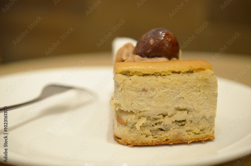 a white plate of a Castanea Cheesecake a white plate of a Castanea Cheesecake