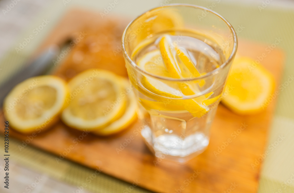 Close up of a lemon slices and a glass of water. Healthy food or drink concept. Close up of a lemon slices and a glass of water. Healthy food or drink concept.