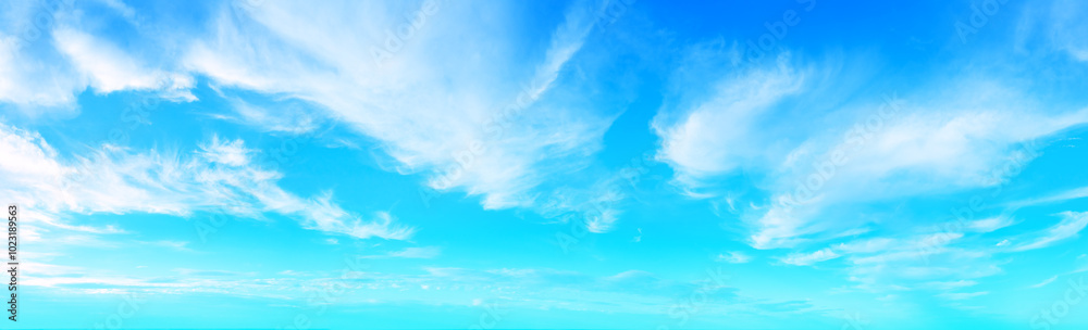 Blue cloudy sky on a sunny day. Sky texture. Abstract nature background. Horizontal banner