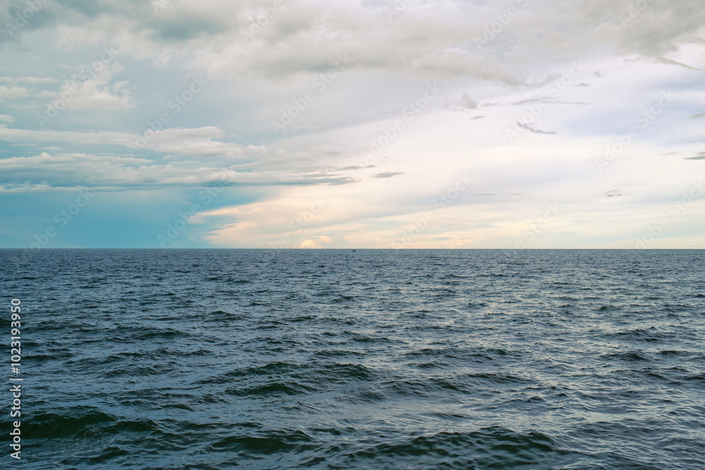 Fototapeta premium Tropical sea with deep blue wave and small fishing boat