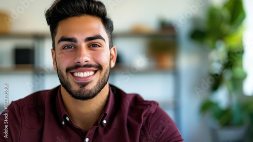 Portrait of a smiling young man with a beard.