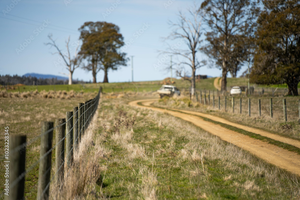 driving down a dirt road gravel road in outback australia in a ute truck on a farm by a wire fence driving down a dirt road gravel road in outback australia in a ute truck on a farm by a wire fence
