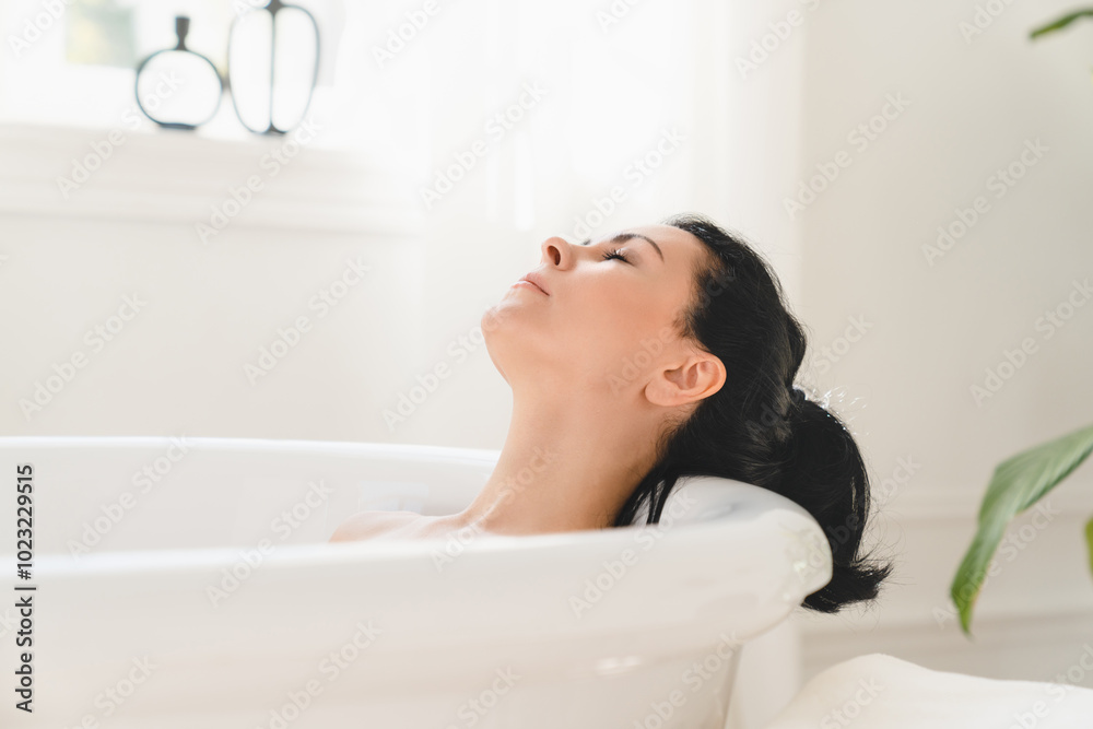 Rejuvenation in spa after work. Serene caucasian mature middle-aged woman relaxing resting in bath warm water at home Rejuvenation in spa after work. Serene caucasian mature middle-aged woman relaxing resting in bath warm water at home