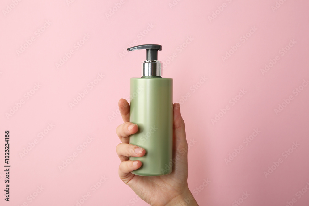 Woman with shampoo bottle on pink background, closeup Woman with shampoo bottle on pink background, closeup