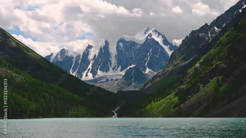 tamlaps, clouds are floating fast over a mountain lake and beautiful mountains in Altai tamlaps, clouds are floating fast over a mountain lake and beautiful mountains in Altai