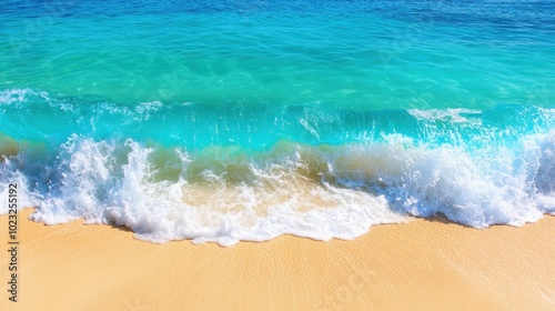 Crystal clear turquoise waves crashing on sandy beach