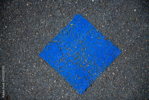 blue square painted on the asphalt