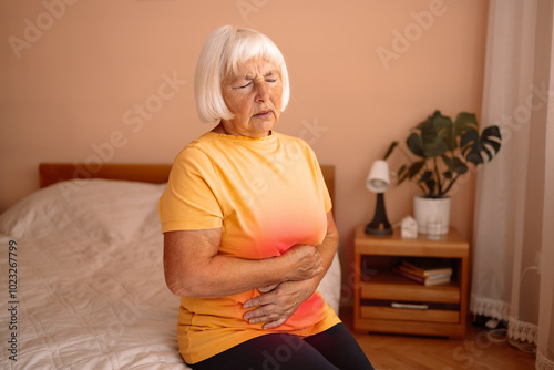 Abdominal pain in elder senior mature aging woman with stomachache illness from stomach cancer, irritable bowel syndrome, Indigestion, Diarrhea, gastroparesis or GERD 