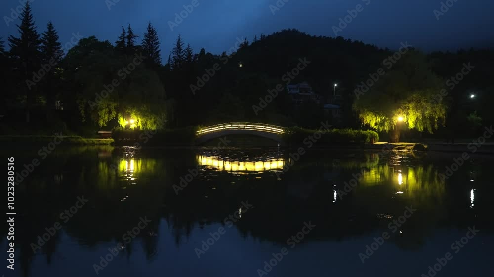 Dilijan lake at night with illuminated bridge Dilijan lake at night with illuminated bridge
