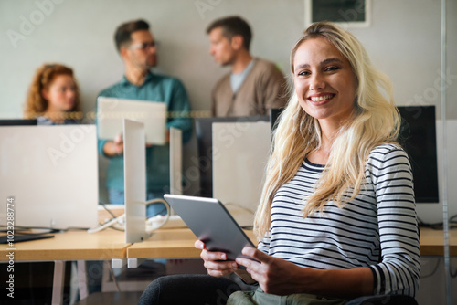 Successful young business woman standing in creative modern office. Success woman concept.