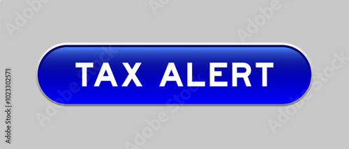 Blue color capsule shape button with word tax alert on gray background