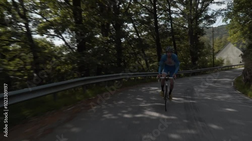 Wallpaper Mural Front-Facing Follow Shot of a Road Cyclist Whizzing Down Empty Roads Amidst Stunning Scenery in Norway Torontodigital.ca