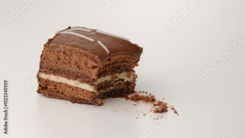 Cutting a slice of chocolate cake with spoon. Stop motion.