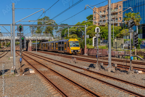 Photography Commuter Passenger Train moving fast moving through a Burwood Train Station in S