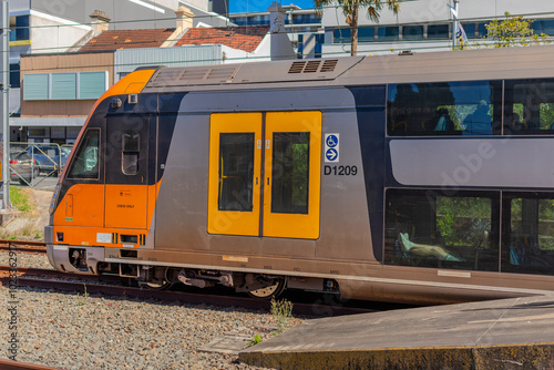 Canvas Print Commuter Passenger Train moving fast moving through a Burwood Train Station in S