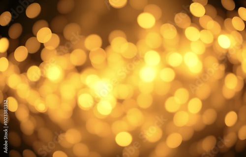 Golden Christmas background with abstract bokeh effect. Blurred glittering lights and sparkles create a luxurious atmosphere. Magical festive background with space for text, perfect for greeting cards