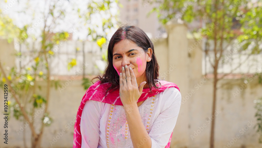 Indian Woman Giving Flying Kiss in Camera with Holi Color on Face Indian Woman Giving Flying Kiss in Camera with Holi Color on Face