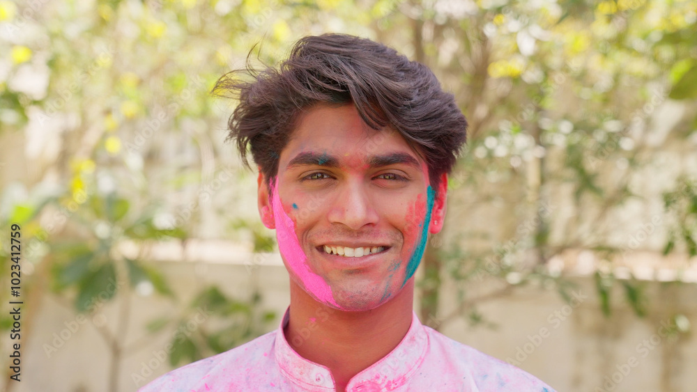 Closeup of Indian Man Smiling at Camera with Holi Color on Face Closeup of Indian Man Smiling at Camera with Holi Color on Face