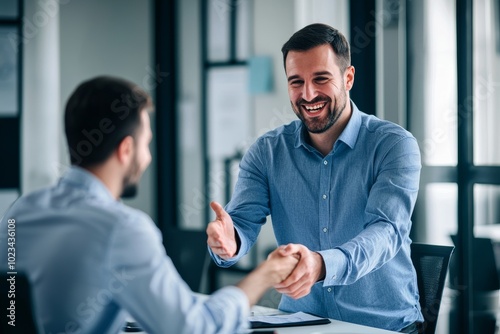 As a business partner and he shake hands after signing an agreement in the office, a 40-year-old businessman smiles