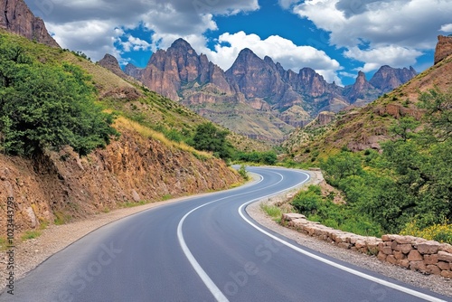 Winding Mountain Road with Numerous Turns Surrounded by Lush Greenery