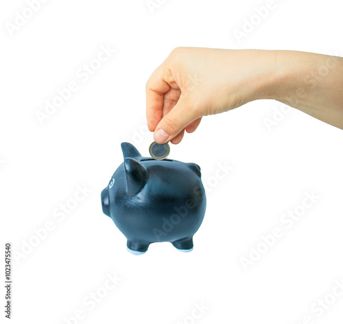 putting coins into a black piggy bank, piggy bank, Saving money for future plans and retirement fund