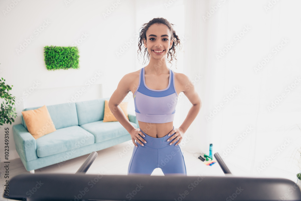 Confident young woman in stylish activewear enjoys a home workout in modern living room natural daylight, focusing on fitness wellness. Confident young woman in stylish activewear enjoys a home workout in modern living room natural daylight, focusing on fitness wellness.