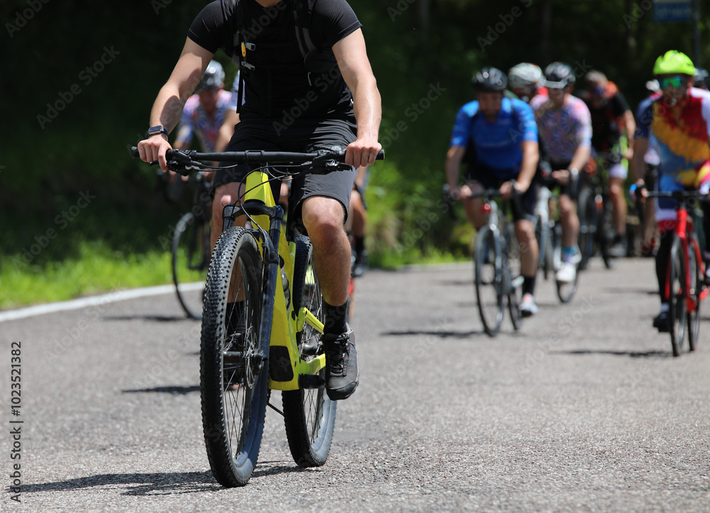 Fototapeta premium group of cyclists competing on a gravel bike race course with many paved road