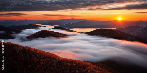 A breathtaking sunrise bathes misty mountains in vibrant colors, creating a tranquil landscape. Ideal for nature and travel enthusiasts seeking scenic beauty.