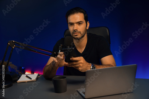 Obraz na płótnie Broadcaster talking to listener on live streaming online, checking message from smartphone on social media in host channel by creative positive thinking concept at purple neon light studio. Surmise. w salonie