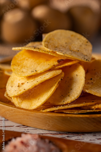 Potato chips on a wooden table. 