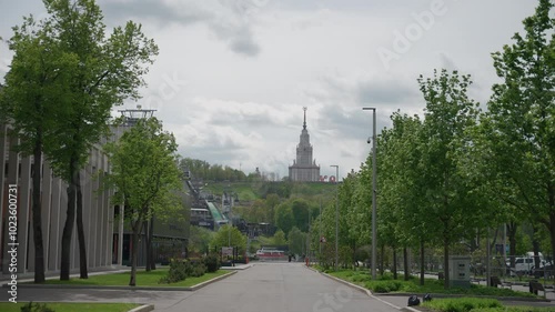 View of the main building of Moscow State University from the park in the summer . Dolly camera